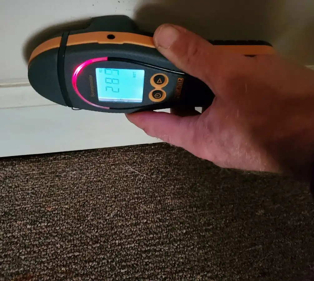 Moisture detection at baseboard during Storm Damage Restoration in Manor